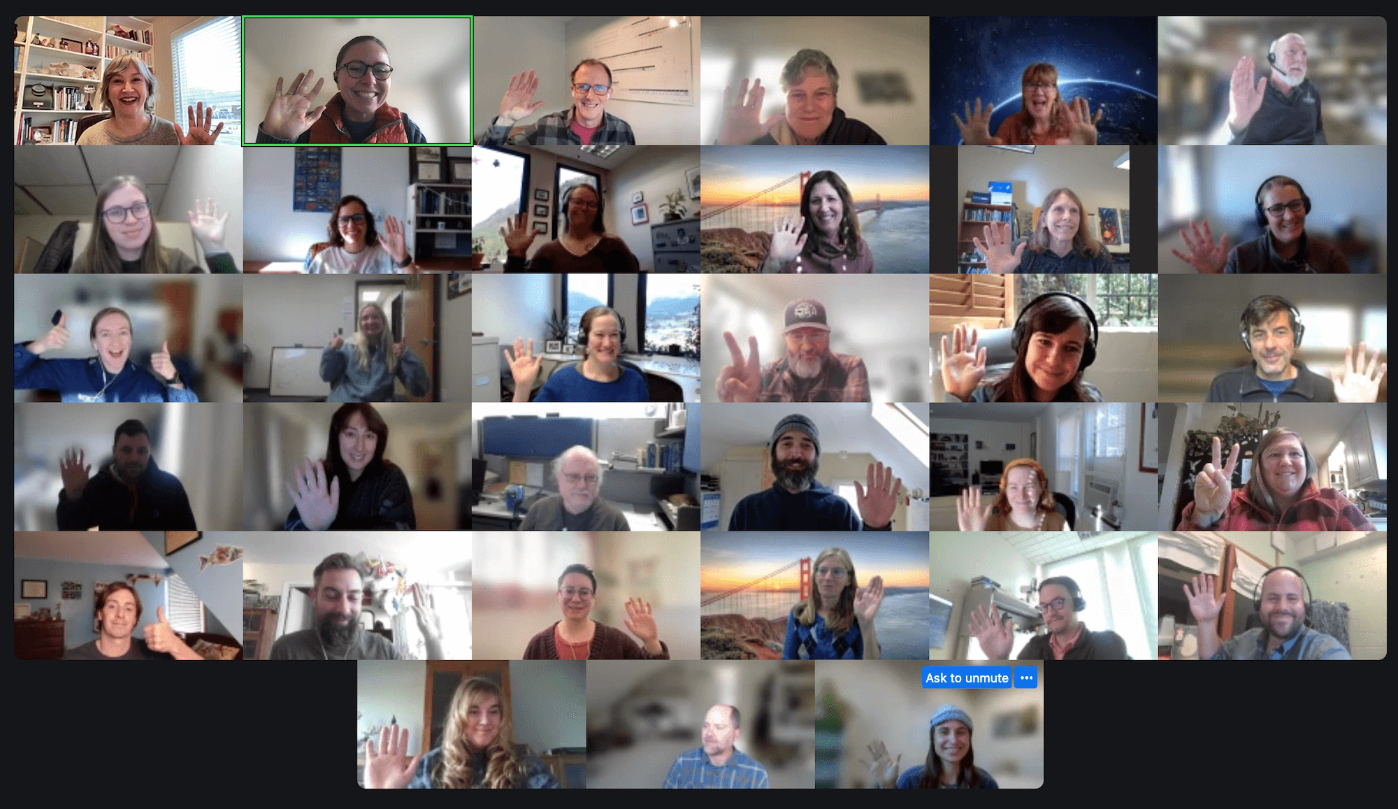 headshots in zoom meeting. a 7 by 6 grid of people smiling and waving